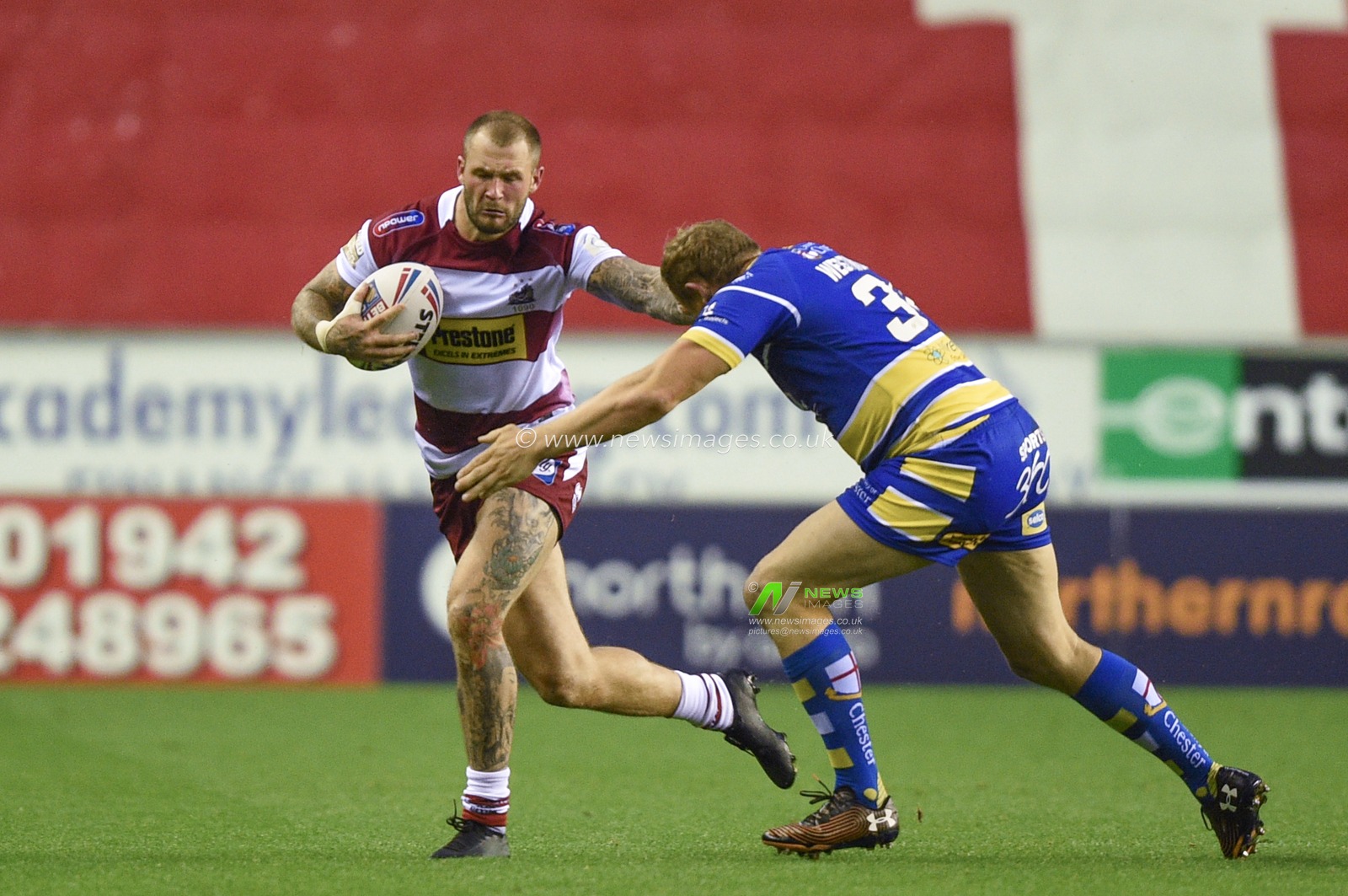 16th August 2019 , DW Stadium, Wigan, England;  Betfred Super League, Round 26, Wigan Warriors vs Warrington Wolves ; Zak Hardaker of Wigan Warriors is tackled by Ben Westwood of Warrington Wolves 

Credit: Richard Long/News Images
