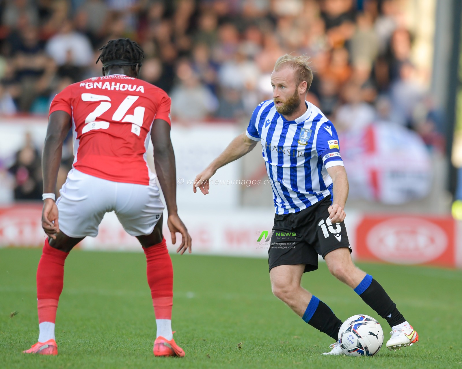 Barry Bannan #10 of Sheffield Wednesday looks for a way past Arthur Gnahoua #24 of Morecambe