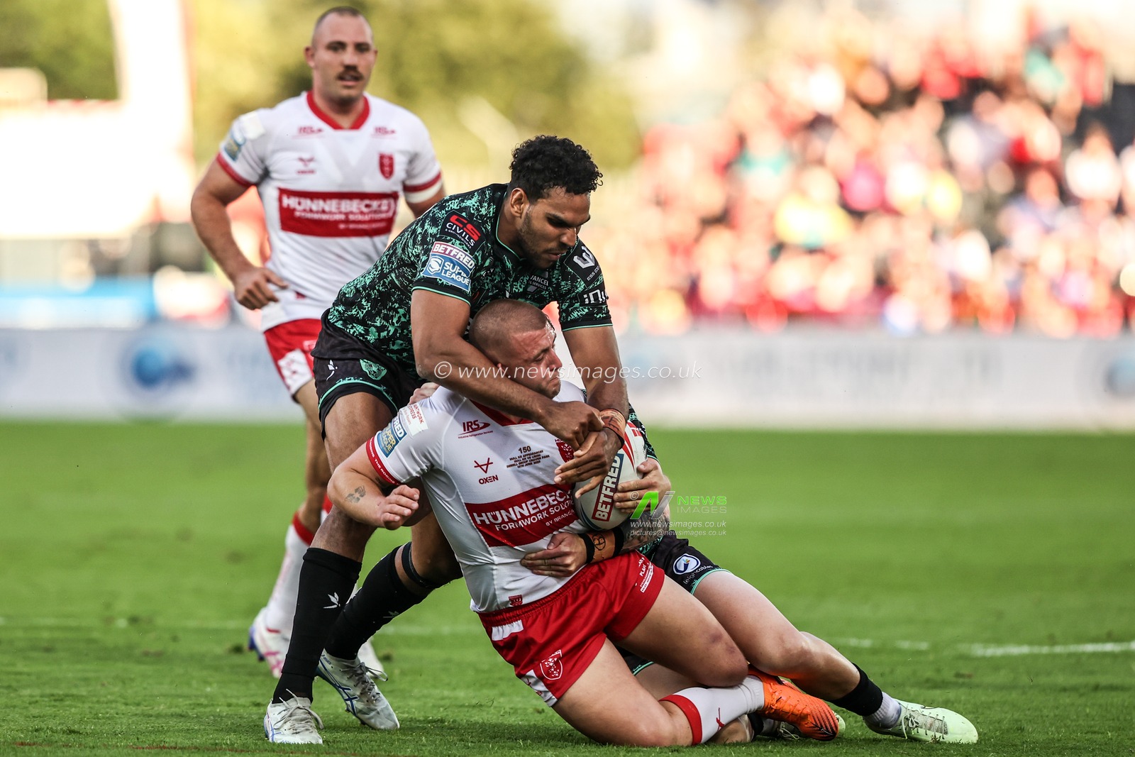 Mikey Lewis of Hull KR is tackled by Jacob Alick-Wiencke of Leigh Leopards and Adam Cook of Leigh Leopards during the Betfred Super League round 15 match Hull KR vs Leigh Leopards at Sewell Group Craven Park, Hull, United Kingdom on 19 June 2026

(Photo by Alfie Cosgrove/News Images)