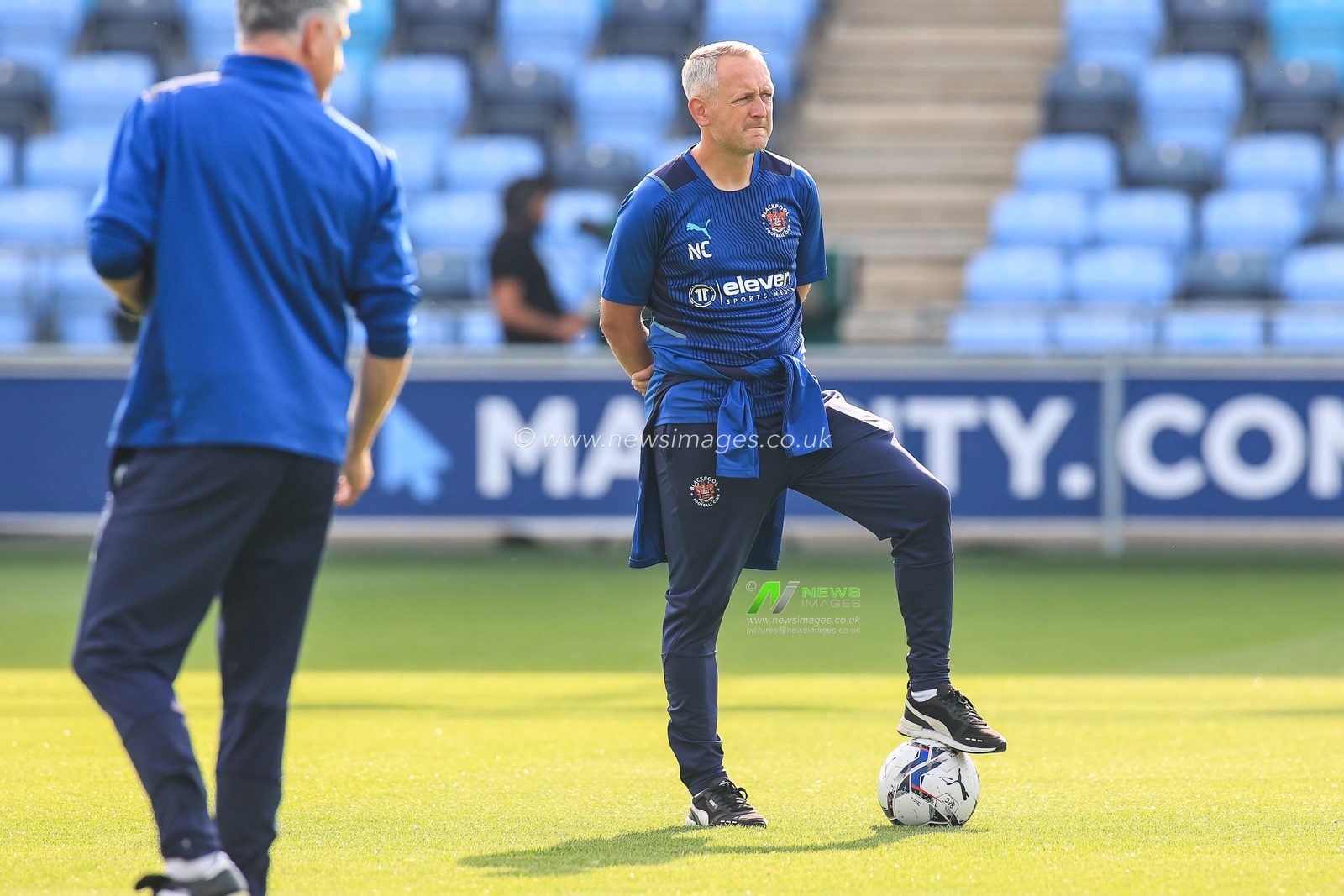 Neil Critchley manager of Blackpool watches Manchester City players warming up
