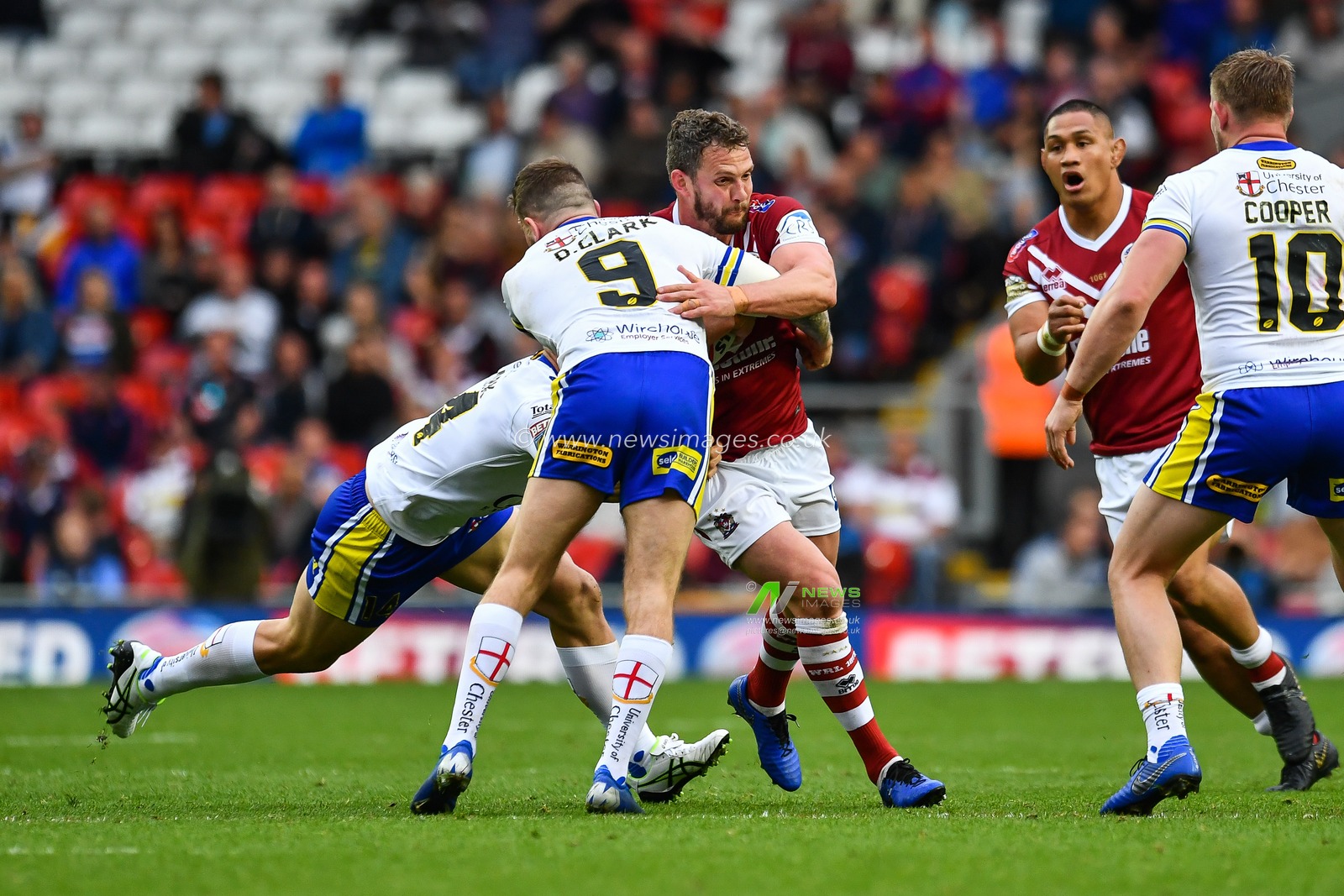 25th May 2019 , Anfield Stadium, Liverpool, England; Dacia Magic Weekend, Betfred Super League Round 16, Wigan Warriors vs Warrington Wolves ; Sean Oâ€™Loughlin (13) of Wigan Warriors is tackled by Daryl Clark (9) of Warrington Wolves 

Credit: Craig Thomas/News Images