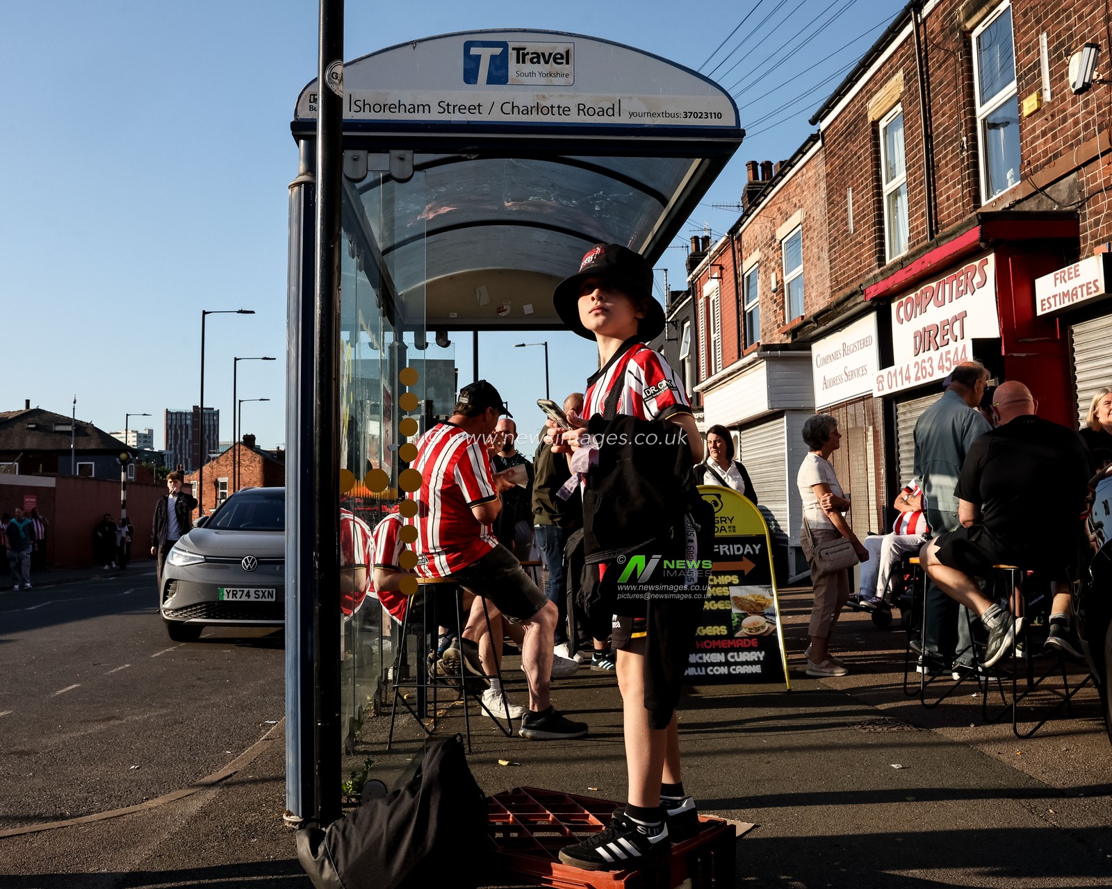 A young Sheffield United fans stands on a milk crate in a bus stop outside Bramall Lane during the Sky Bet Championship Playoff Semi-final match Sheffield United vs Bristol City at Bramall Lane, Sheffield, United Kingdom, 12th May 2025

(Photo by Mark Cosgrove/News Images)