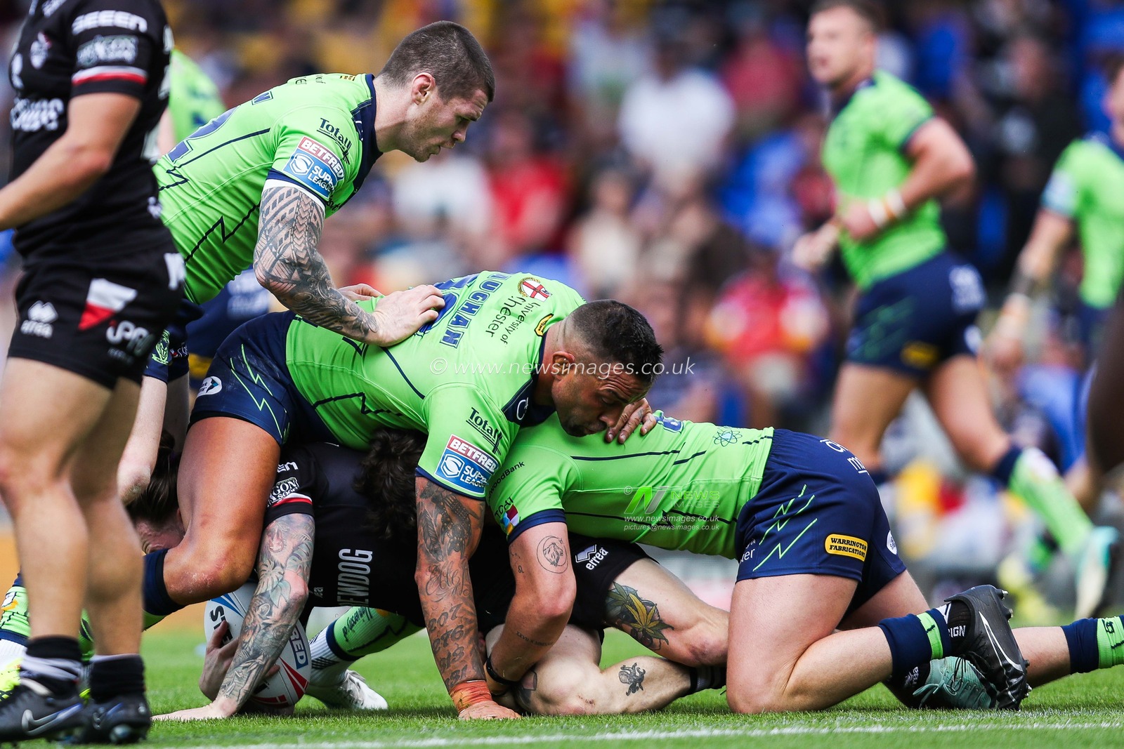 John Bateman and Paul Vaughan of Warrington Wolves in a ruck during the Betfred Super League Round 21 match London Broncos vs Warrington Wolves at Plough Lane, Wimbledon, United Kingdom, 11th August 2024

(Photo by Izzy Poles/News Images)