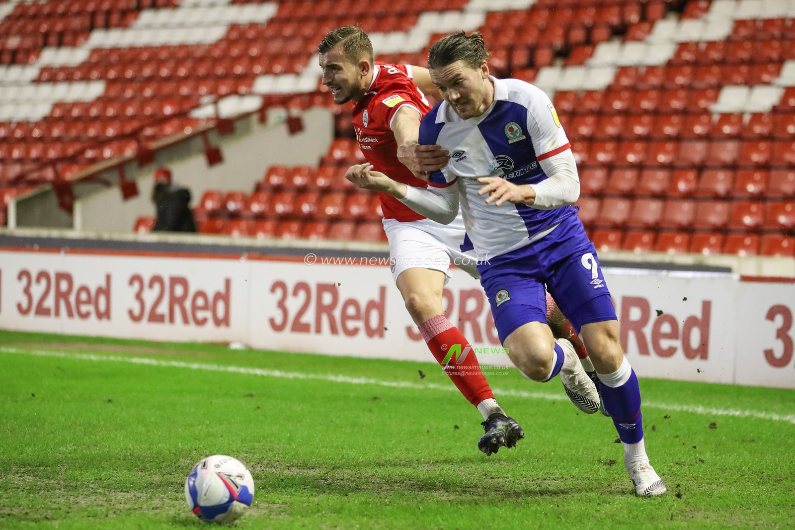 Sam Gallagher #9 of Blackburn Rovers flyâ€™s past MichaÅ‚ Helik #30 of Barnsley in the corner