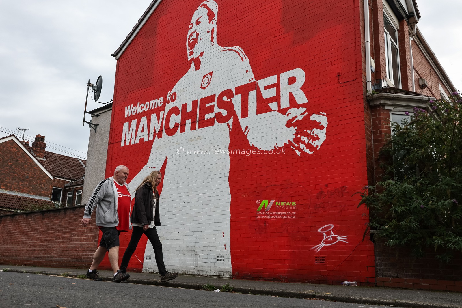Manchester United fans pass the Mary Earps Muralas they make their way to Old Trafford during the Premier League match Manchester United vs Tottenham Hotspur at Old Trafford, Manchester, United Kingdom, 29th September 2024

(Photo by Mark Cosgrove/News Images)