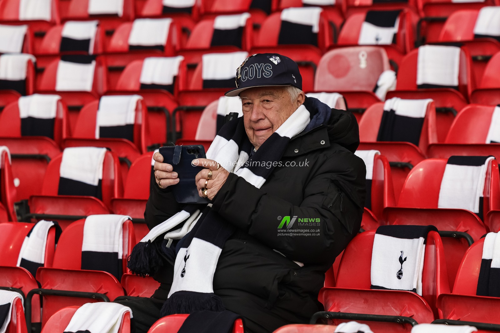 A Tottenham fan takes to his seat wearing his free scarf during the Premier League match Nottingham Forest vs Tottenham Hotspur at City Ground, Nottingham, United Kingdom, 14th December 2025

(Photo by Mark Cosgrove/News Images)

*** GER AUT SUI OUT ***