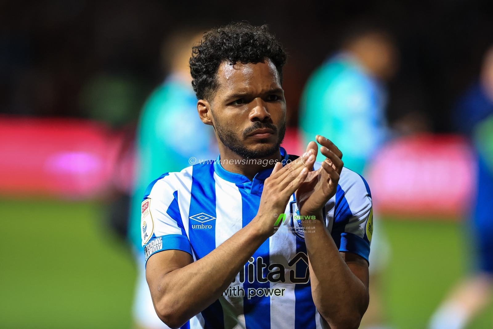 Duane Holmes #19 of Huddersfield Town applauds the traveling fans