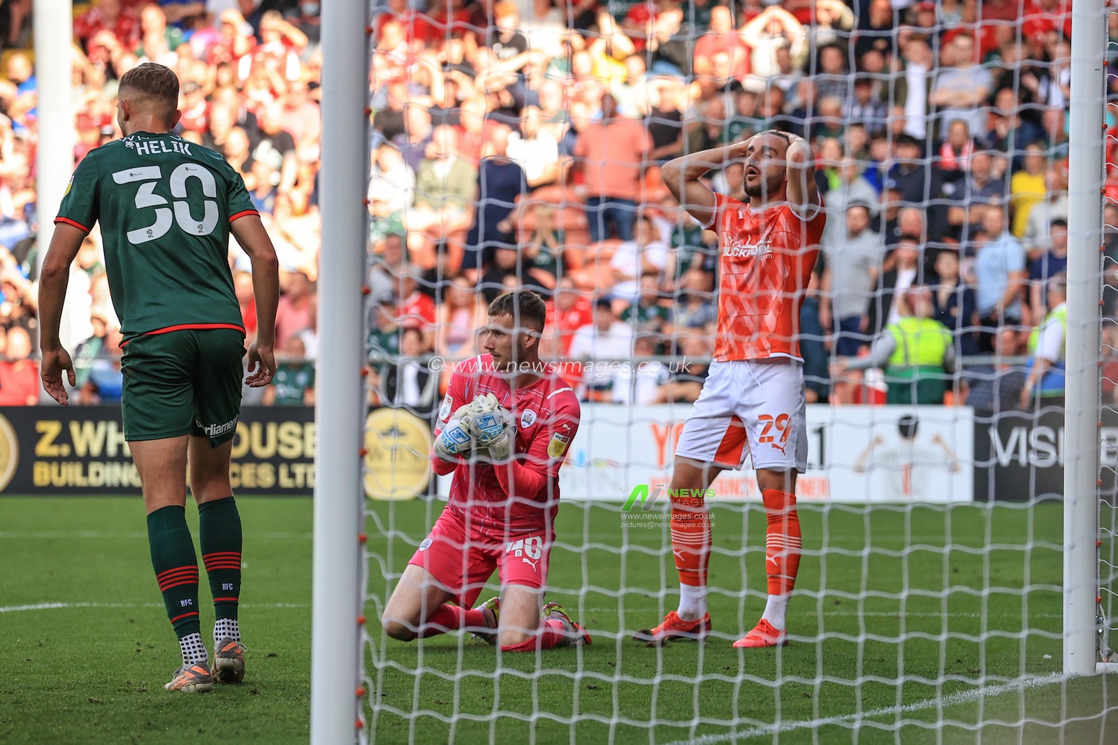 Luke Garbutt #29 of Blackpool reacts as Bradley Collins #40 of Barnsley saves his shot on goal