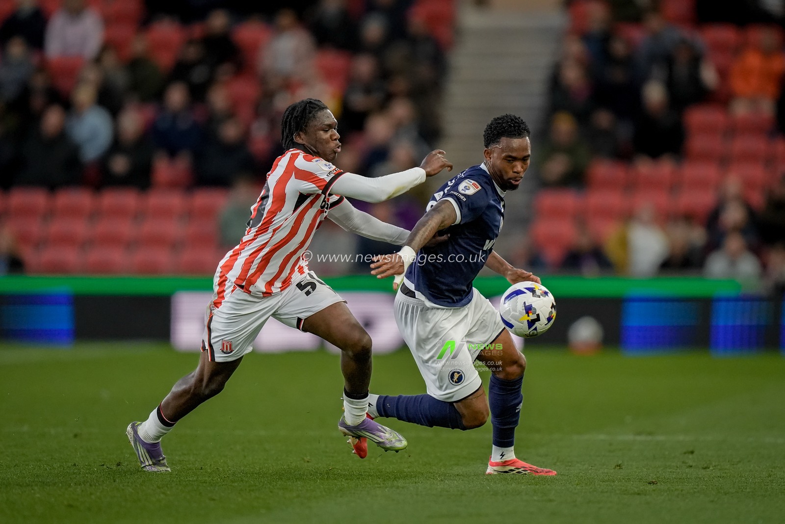 Zak Sturge of Millwall battles for the ball  Sydney Agina of Stoke City during the Sky Bet Championship match Stoke City vs Millwall at Bet365 Stadium, Stoke On Trent, United Kingdom on 21 April 2026

(Photo by Maynard Manyowa/News Images)
