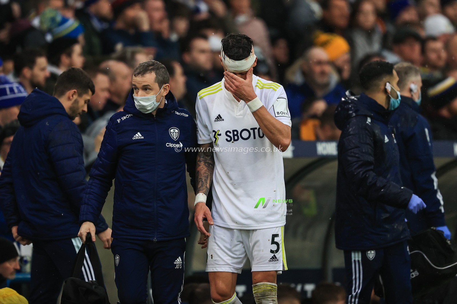 Robin Koch #5 of Leeds United leaves the field due to the head injury
