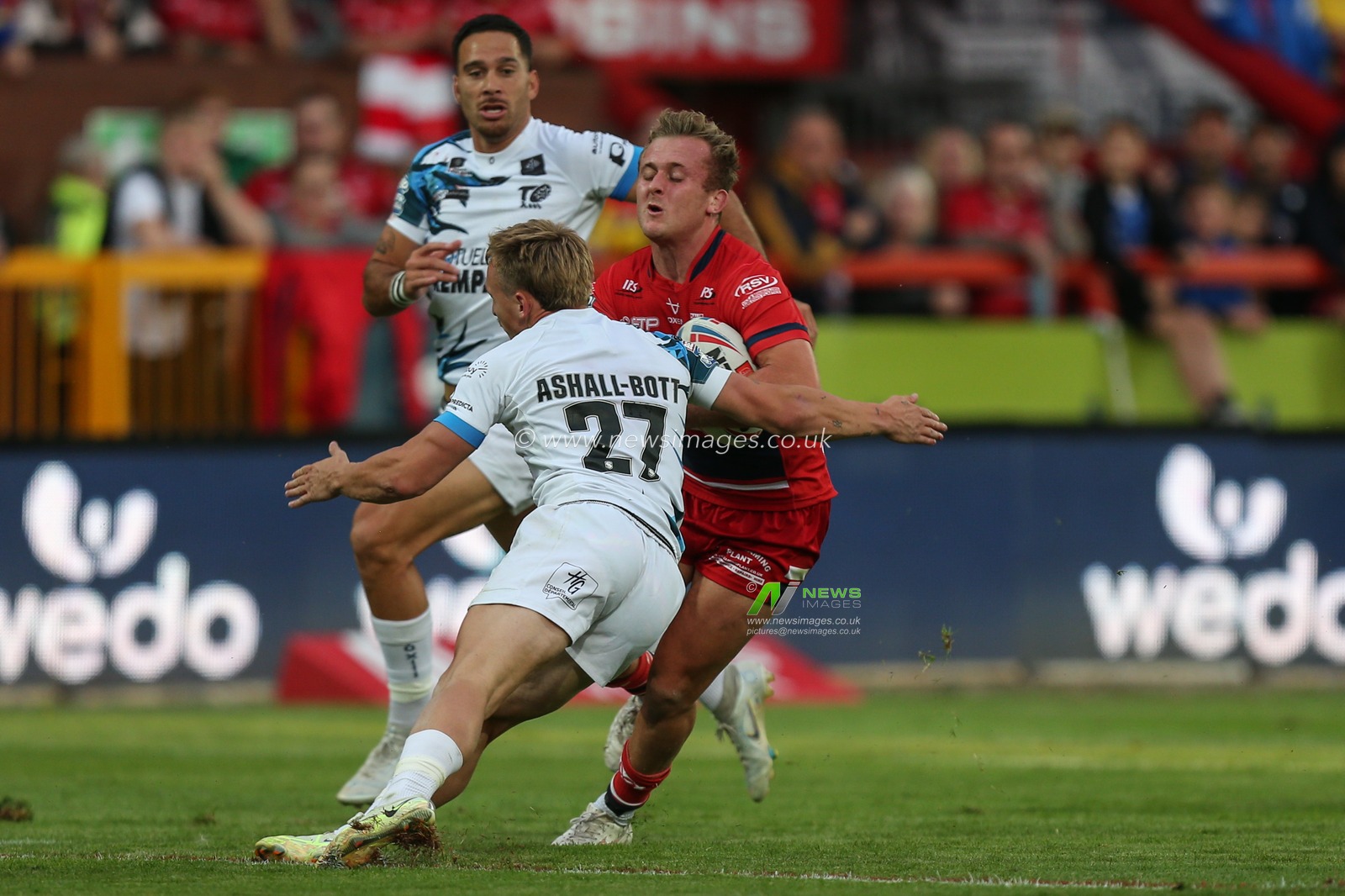 Jez Litten #14 of Hull KR runs at Olly Ashall-Bott #27 of Toulouse Olympique