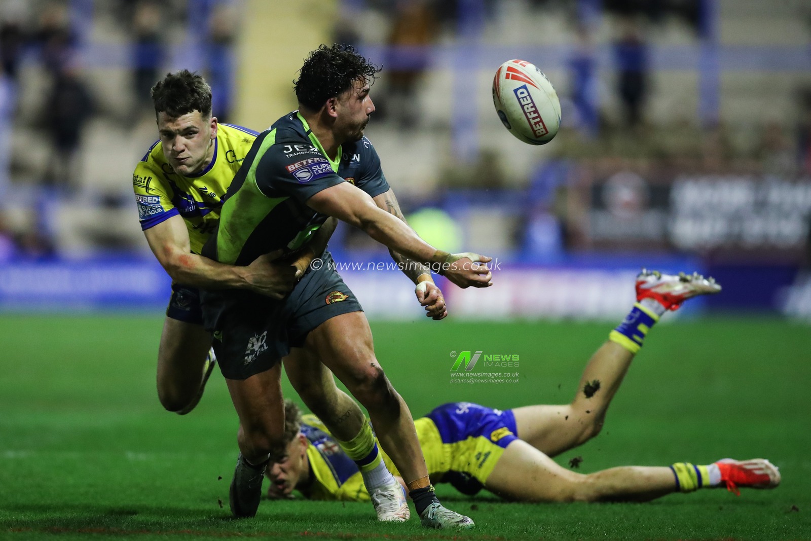 Arthur Romano of Catalan Dragons off loads the ball as he is tackled by Josh Thewlis of Warrington Wolves during the Betfred Super League Round 2 match Warrington Wolves vs Catalans Dragons at Luke Littler Stadium, Warrington, United Kingdom, 21st February 2025

(Photo by Gareth Evans/News Images)