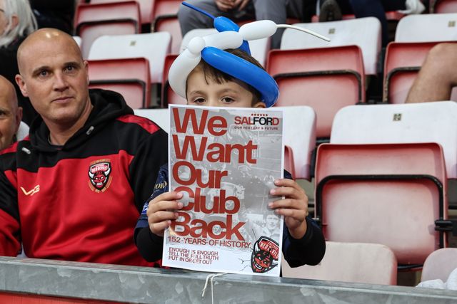 Salford Red Devils fans protest holding up a signs saying “We want out club back” during the Betfred Super League Round 23 match Leigh Leopards vs Salford Red Devils at Leigh Sports Village, Leigh, United Kingdom, 22nd August 2025

(Photo by Mark Cosgrove/News Images)