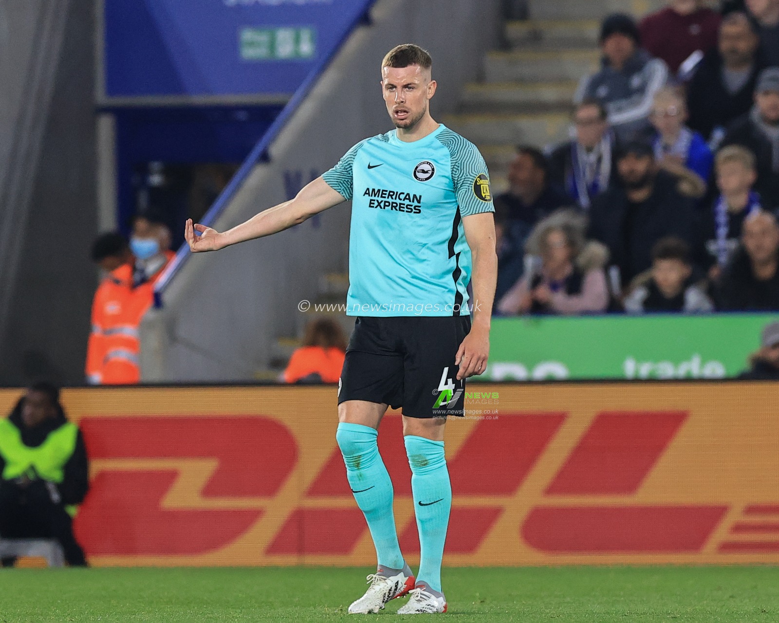 Adam Webster #4 of Brighton & Hove Albion gives his team instructions