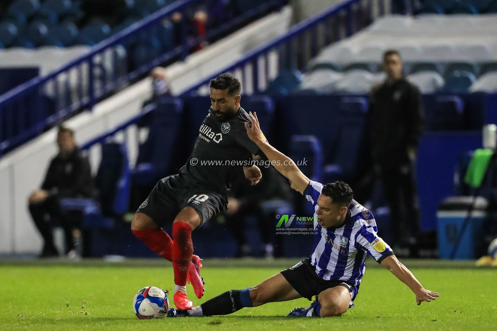 Joey Pelupessy (8) of Sheffield Wednesday is fouled by Saman Ghoddos (20) of Brentford