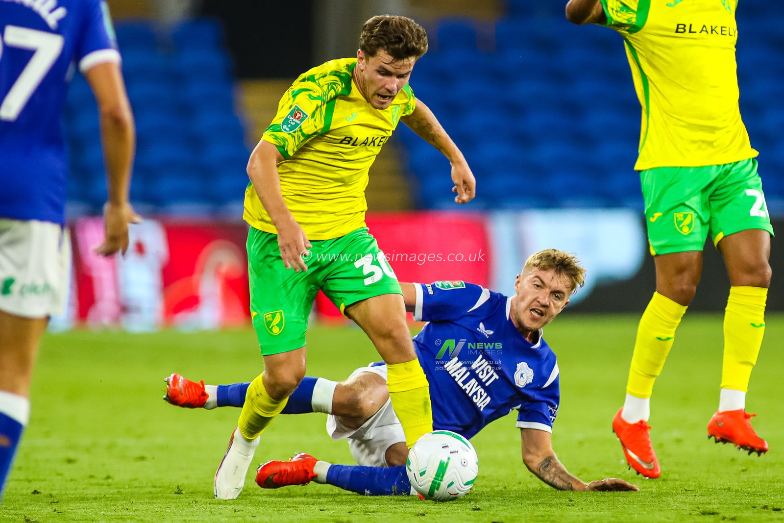 Mathias Kvistgaarden of Norwich City under pressure from Joel Bagan of Cardiff City during the Carabao Cup round 2 match Cardiff City vs Norwich City at Cardiff City Stadium, Cardiff, United Kingdom on 25 August 2026

(Photo by Andrew Lewis/News Images)