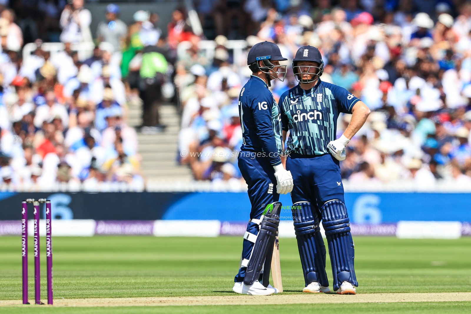 Jason Roy of England chats to Jonny Bairstow after hitting a six