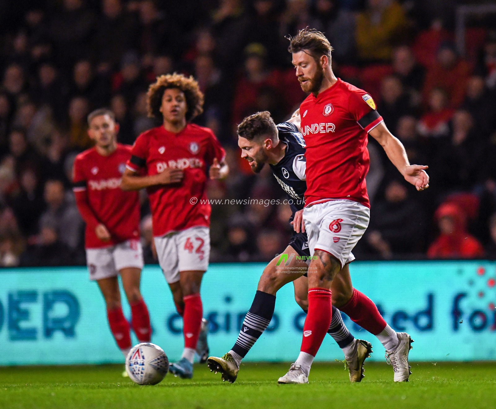 10th December 2019, Ashton Gate, Bristol, England; Sky Bet Championship, Bristol City v Millwall : Nathan Baker (6) of Bristol City under pressure from the Millwall player

Credit: Gareth Dalley/News Images