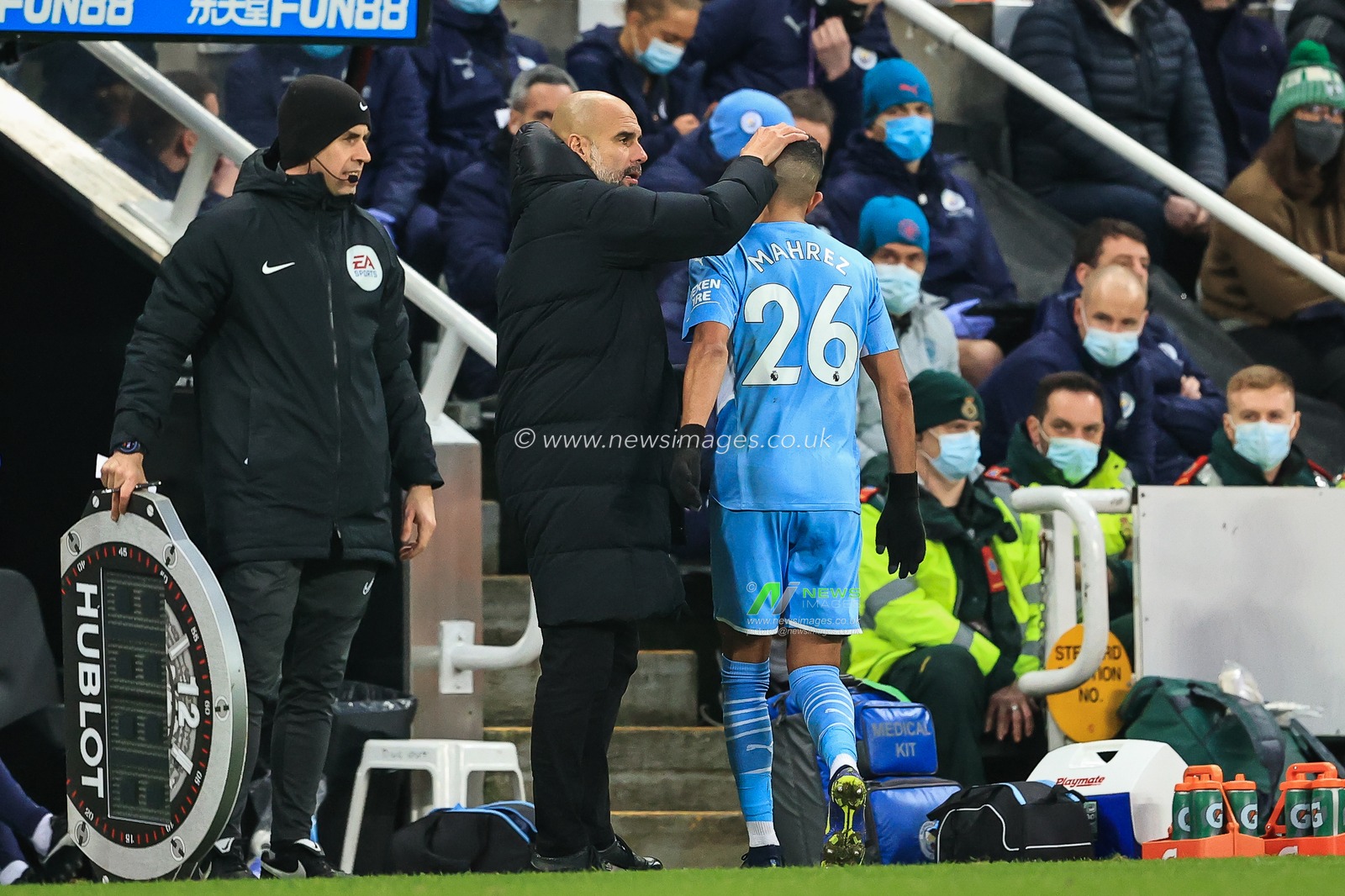 Josep Guardiola manager of Manchester City pats Riyad Mahrez #26 on the head as he comes off the pitch