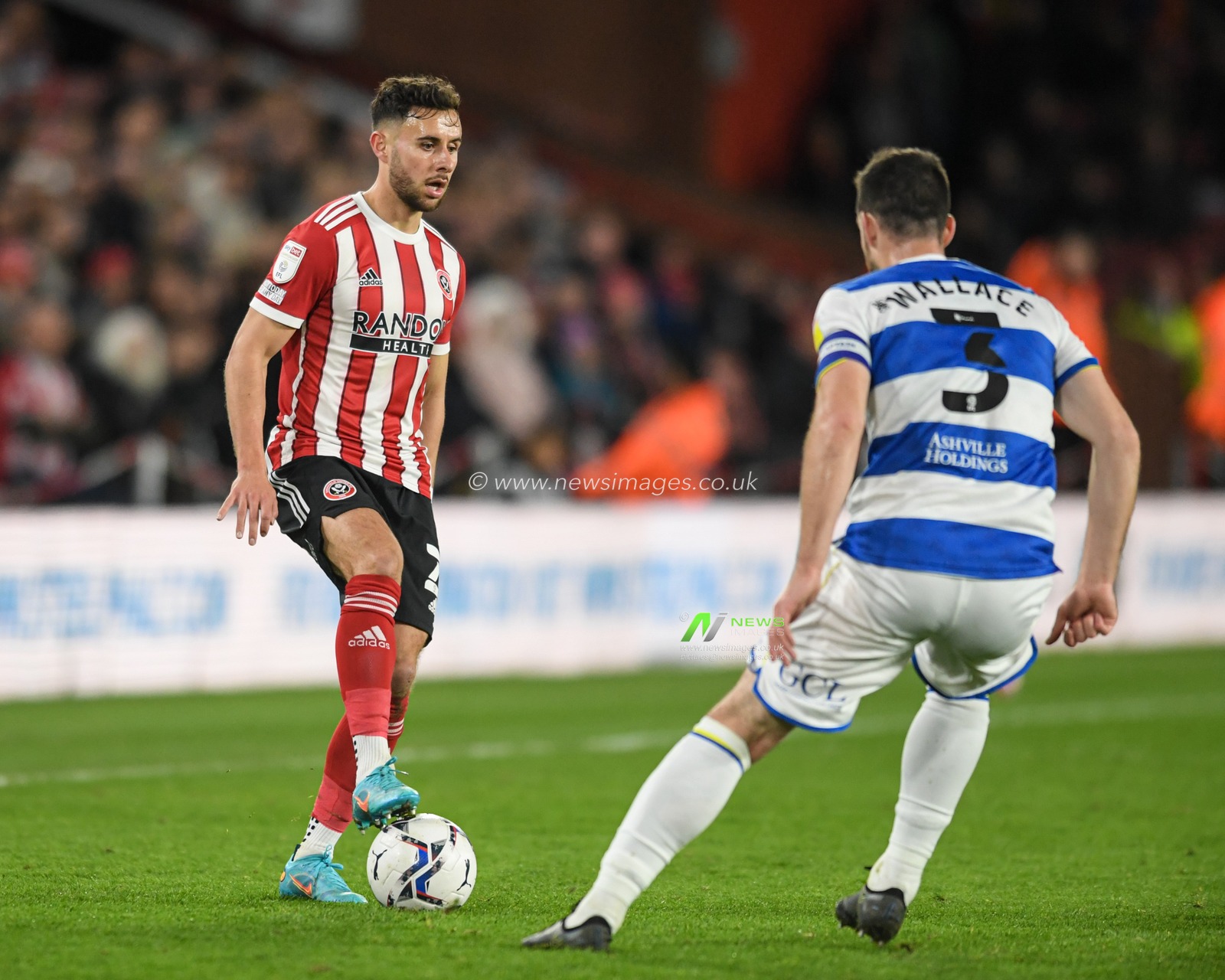George Baldock #2 of Sheffield United looks for a way past Lee Wallace #3 of Queens Park Rangers
