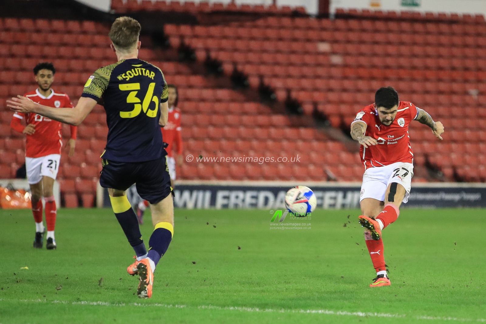 Alex Mowatt #27 of Barnsley shoots on goal, deflected back out