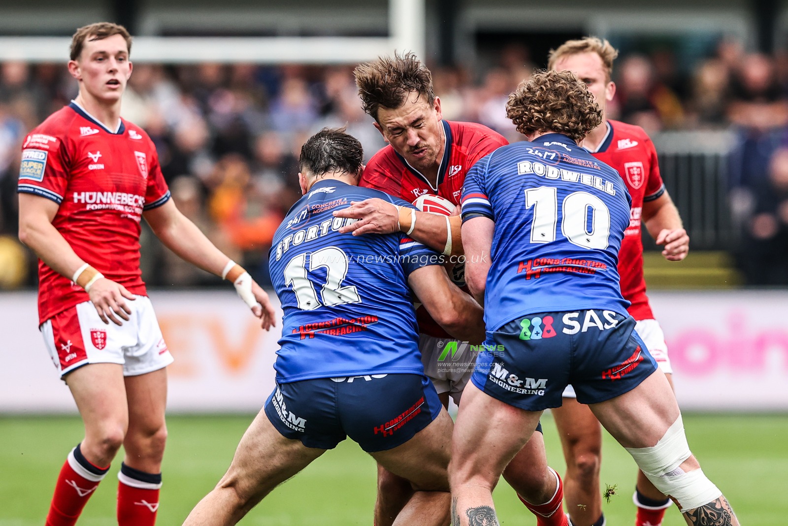 Jai Whitbread of Hull KR is tackled by Matty Storton of Wakefield Trinity and Ky Rodwell of Wakefield Trinity during the Betfred Super League round 13 match Wakefield Trinity vs Hull KR at DIY Kitchens Stadium, Wakefield, United Kingdom on 06 June 2026

(Photo by Alfie Cosgrove/News Images)