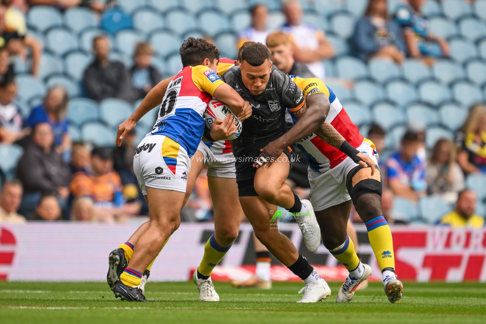 Carlos Tuimavave Hull FC is tackled by Lewis Bienek of London Broncos and Sadiq Adebiyi of London Broncos during the Magic Weekend match Hull FC vs London Broncos at Elland Road, Leeds, United Kingdom, 17th August 2024

(Photo by Craig Thomas/News Images)