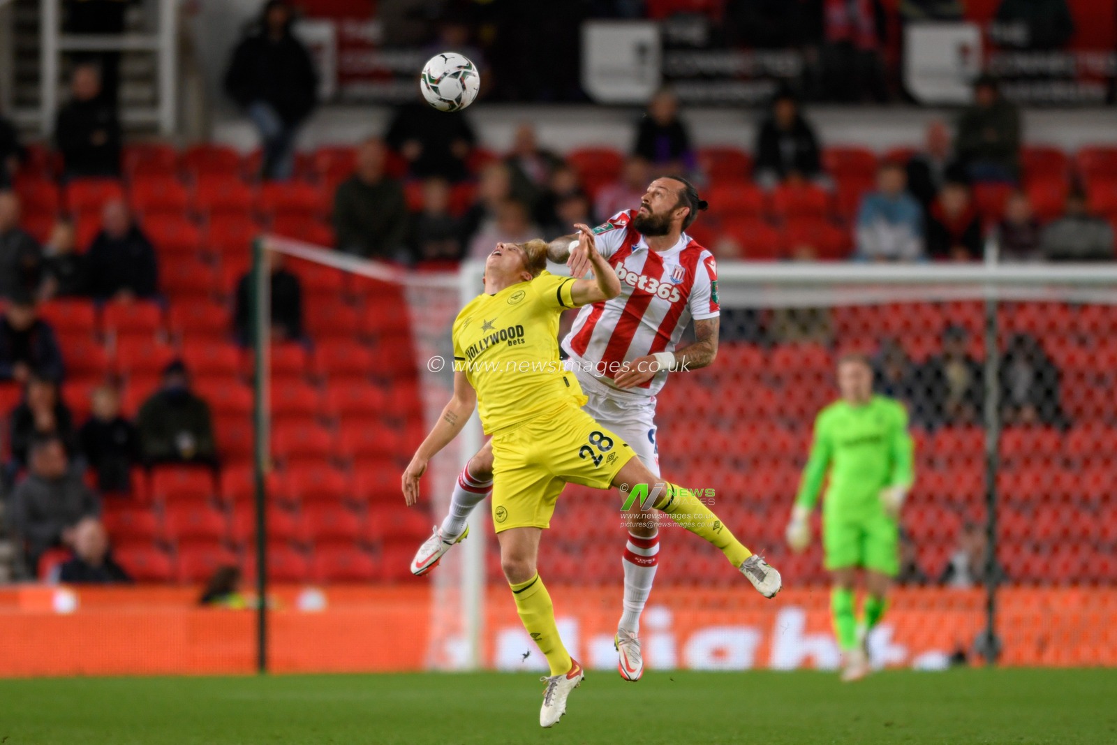 Mads Bidstrup #28 of Brentford and Steven Fletcher #9 of Stoke City compete for the ball