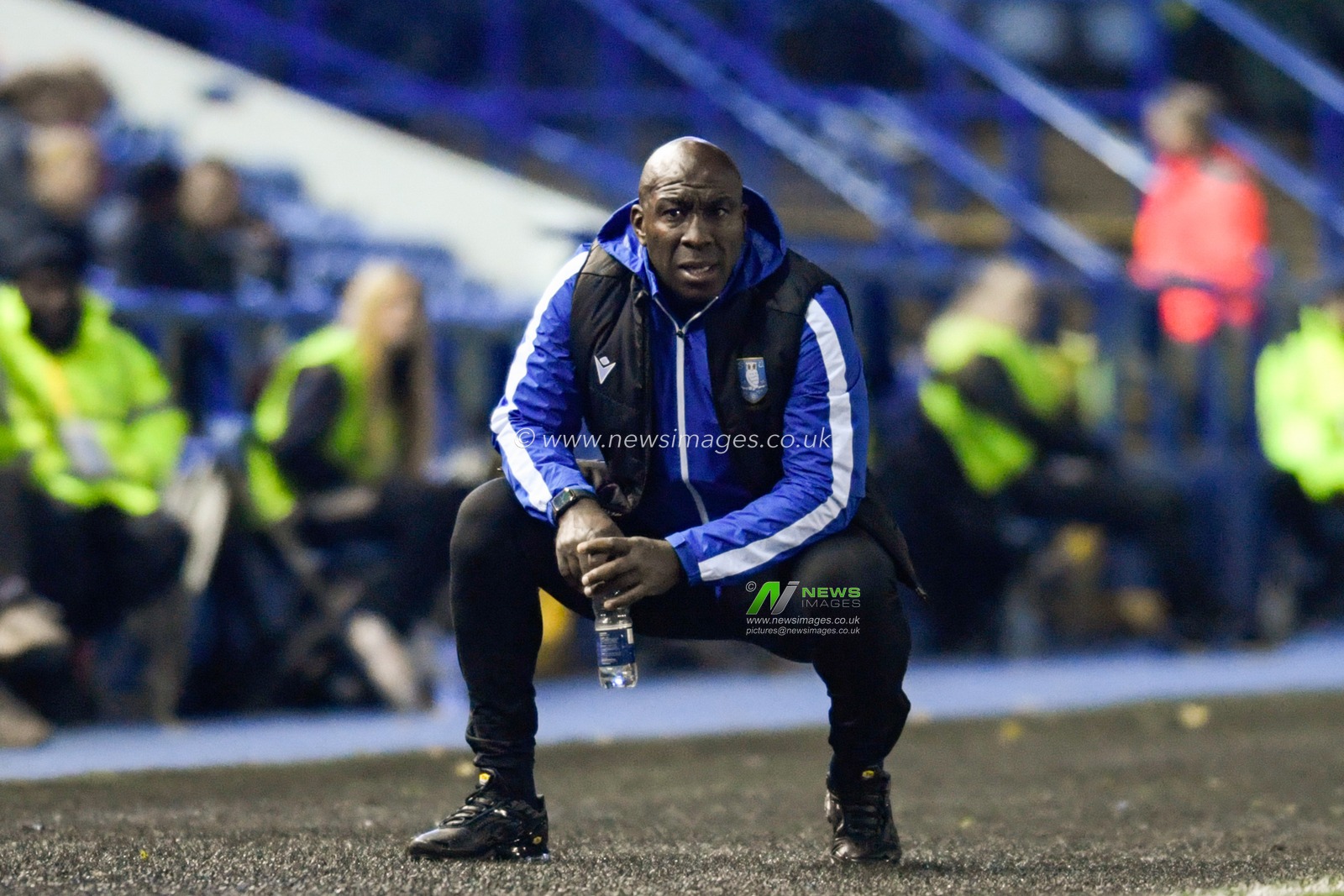 Darren Moore manager of Sheffield Wednesday crouches in the technical area