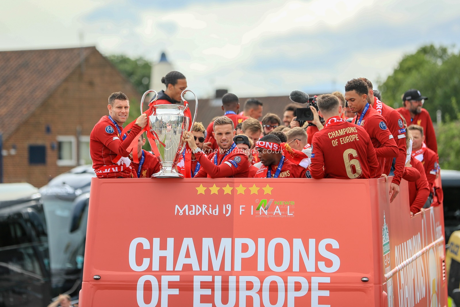 2nd June 2019 , Liverpool, England; UEFA Champions League, Liverpool FC Champions League winners celebrations and open top bus parade ; Liverpool squad on their victory parade as James Milner (07) of Liverpool and â€˜Jordan Henderson (14) of Liverpool hold the Eropean cup 


Credit: Mark Cosgrove/News Images