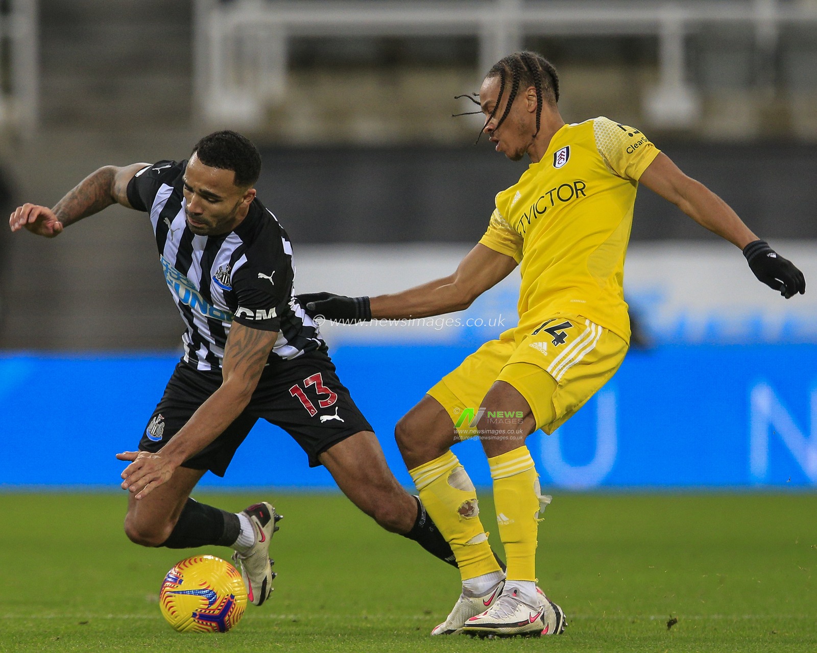 Bobby Decordova-Reid #14 of Fulham fouls Callum Wilson #13 of Newcastle United