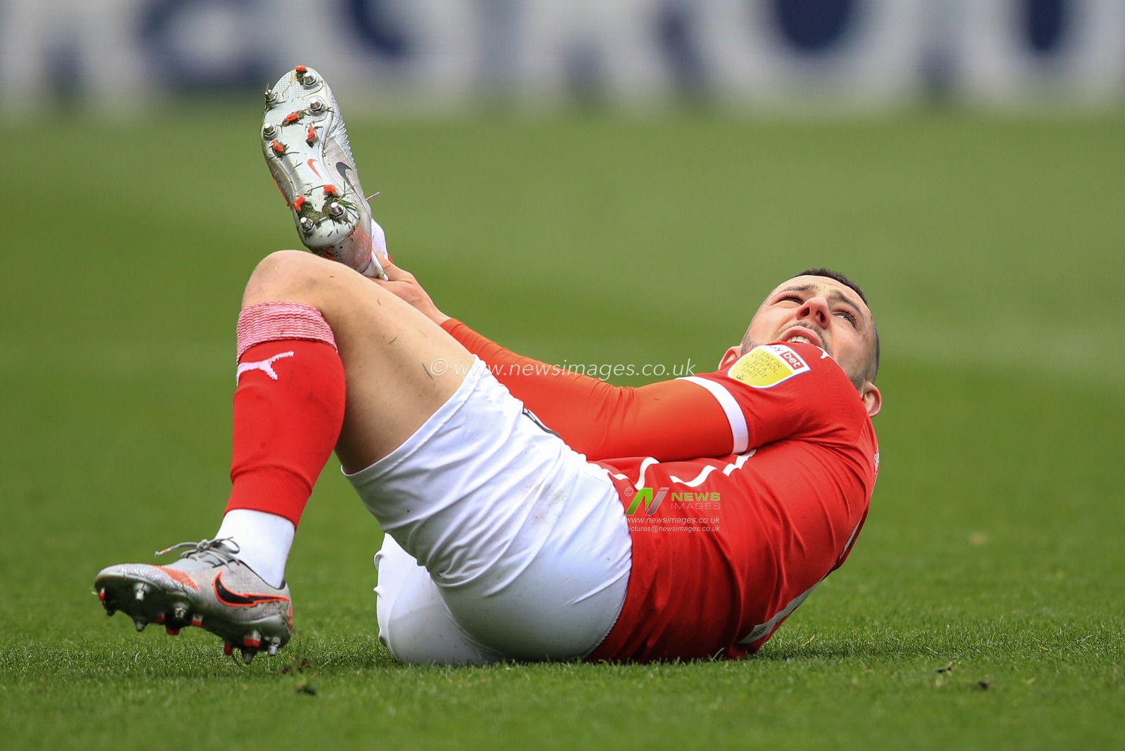 Conor Chaplin #11 of Barnsley picks up a knock to his right ankle