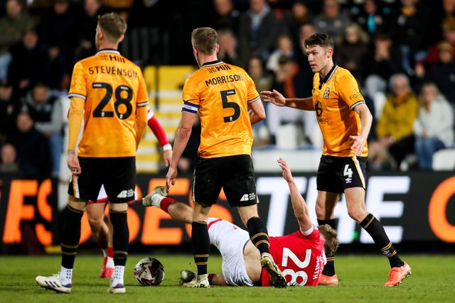 Sam Smith of Wrexham AFC is challenged by Michael Morrison of Cambridge United during the Sky Bet League 1 match Cambridge United vs Wrexham at Abbey Stadium, Cambridge, United Kingdom, 1st April 2025

(Photo by Izzy Poles/News Images)