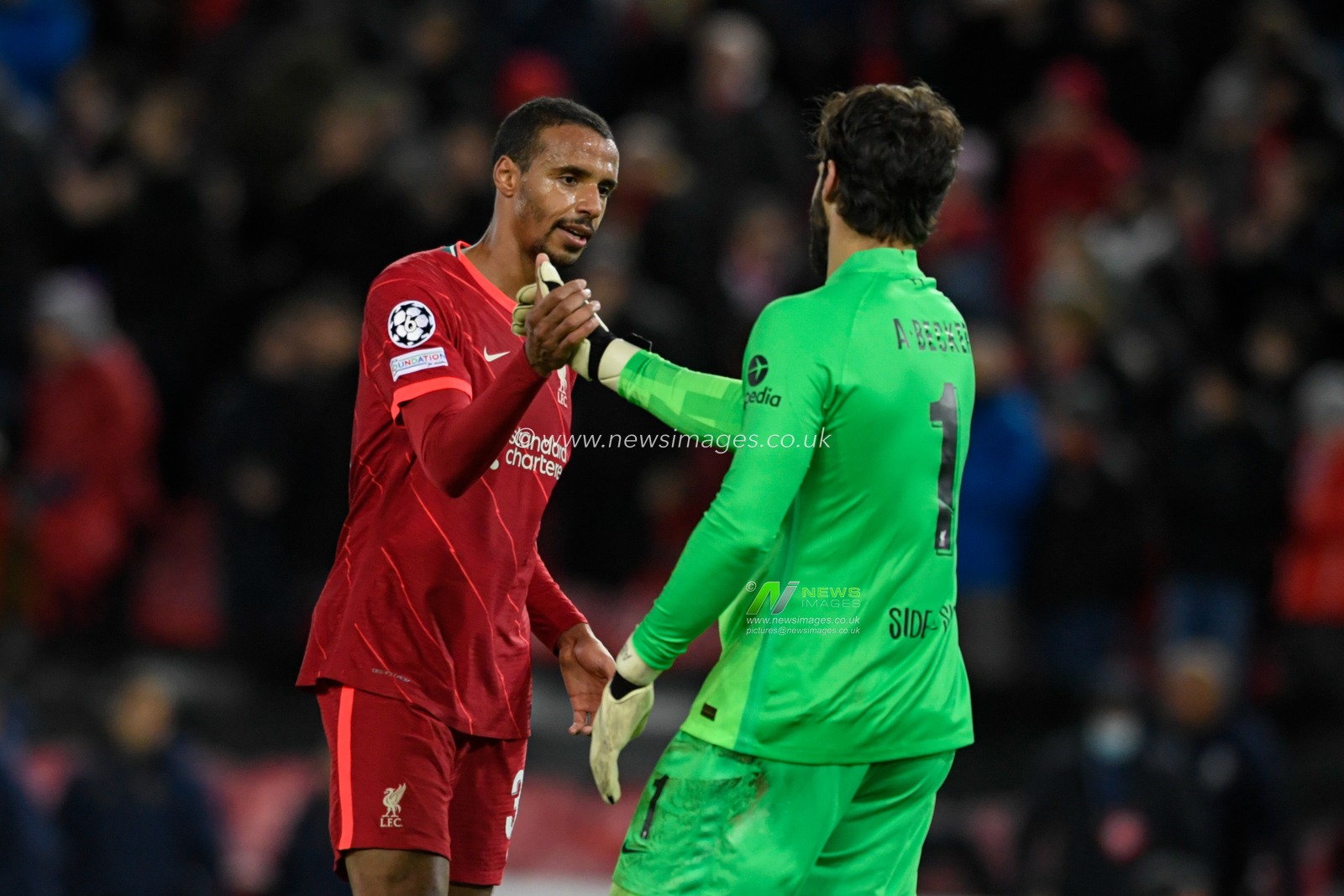 Joel Matip #32 of Liverpool celebrates beating FC Porto 2-0 with Alisson Becker #1 of Liverpool