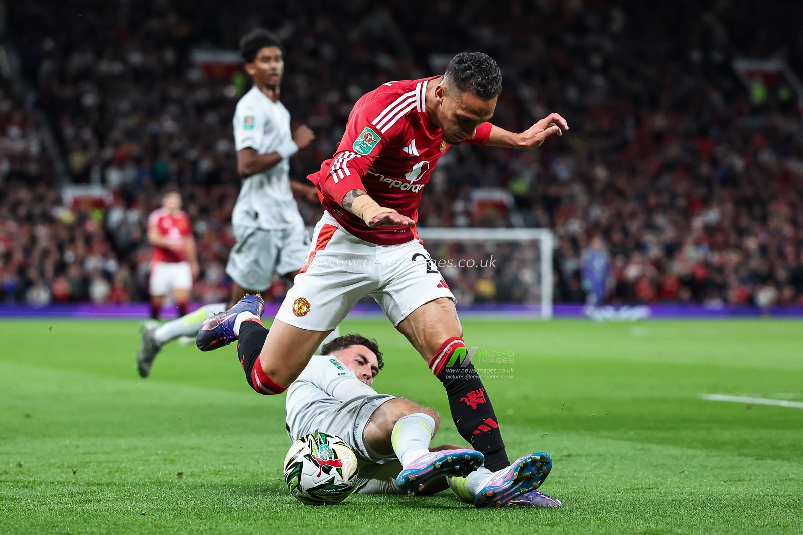 Antony of Manchester United is tackled by Corey O'Keeffe of Barnsley during the Carabao Cup 3rd Round match Manchester United vs Barnsley at Old Trafford, Manchester, United Kingdom, 17th September 2024

(Photo by Mark Cosgrove/News Images)