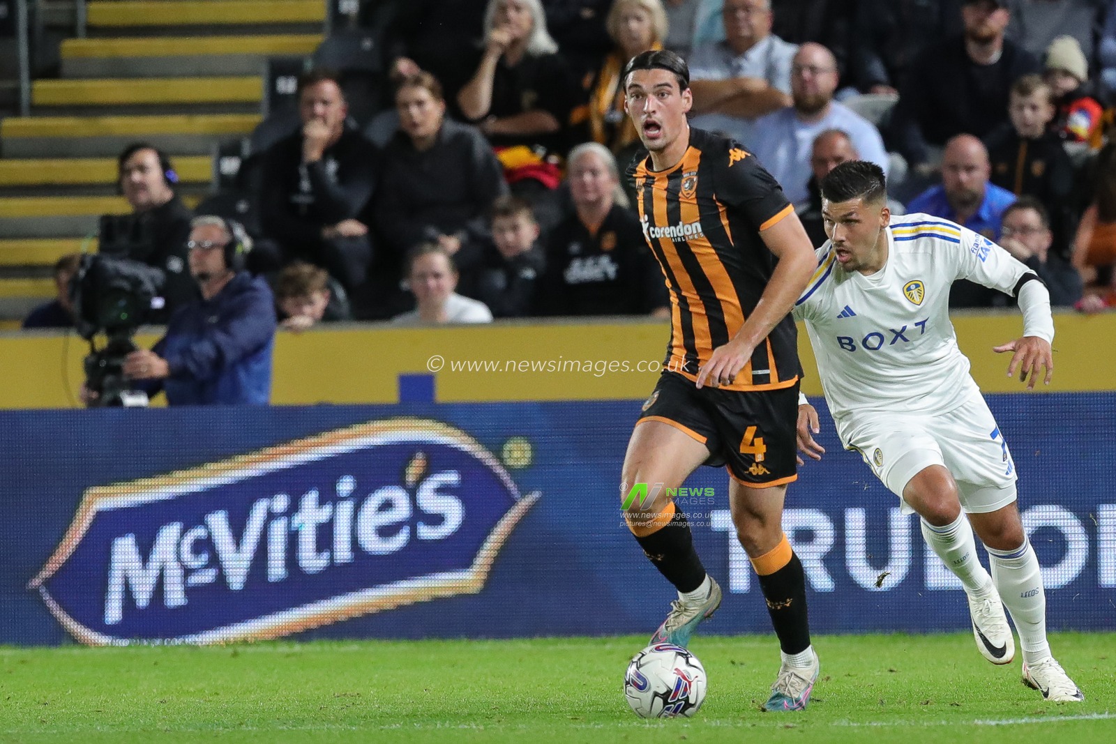New sponsor McVities is illuminated on the LED boards as JoÃ«l Piroe #7 of Leeds United and Jacob Greaves #4 of Hull City battle for the ball during the Sky Bet Championship match Hull City vs Leeds United at MKM Stadium, Hull, United Kingdom, 20th September 2023

(Photo by James Heaton/News Images)