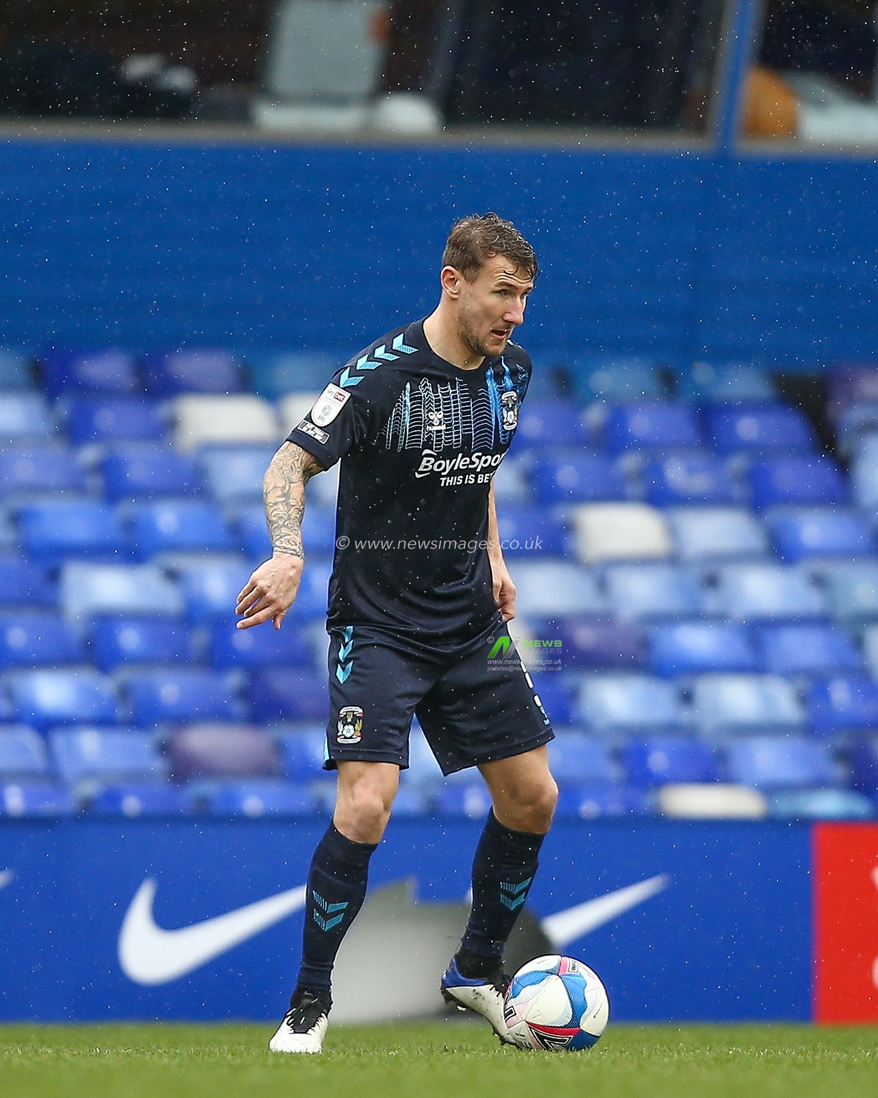 Kyle McFadzean #5 of Coventry City dribbles the ball