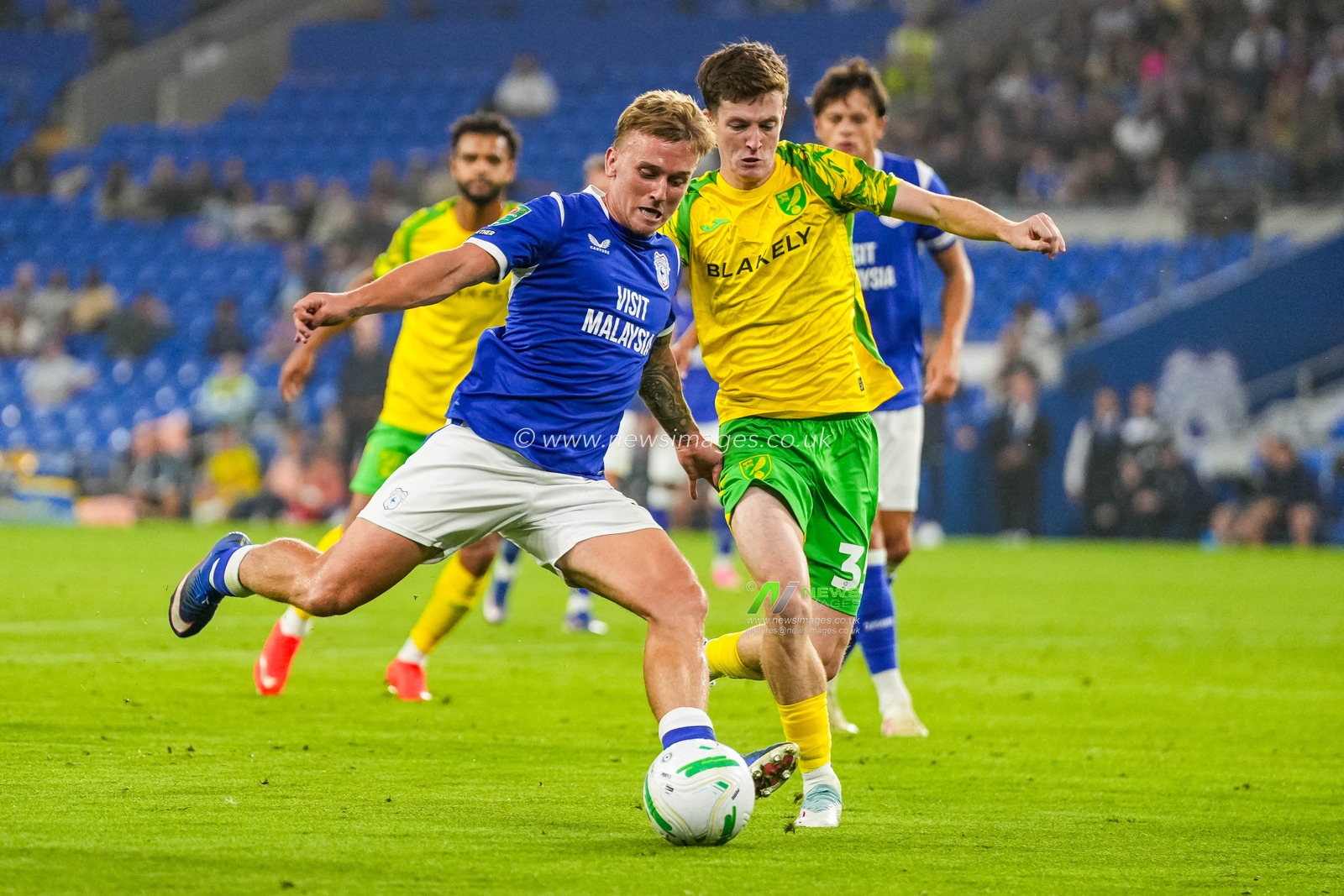 Isaak Davies of Cardiff City under pressure from Kellen Fisher of Norwich City during the Carabao Cup round 2 match Cardiff City vs Norwich City at Cardiff City Stadium, Cardiff, United Kingdom on 25 August 2026

(Photo by Andrew Lewis/News Images)