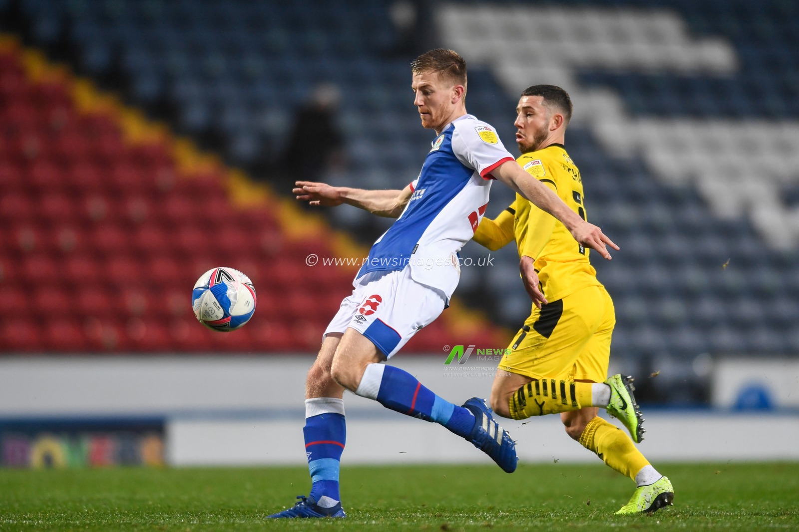 Scott Wharton #28 of Blackburn Rovers shields the ball from Conor Chaplin #11 of Barnsley