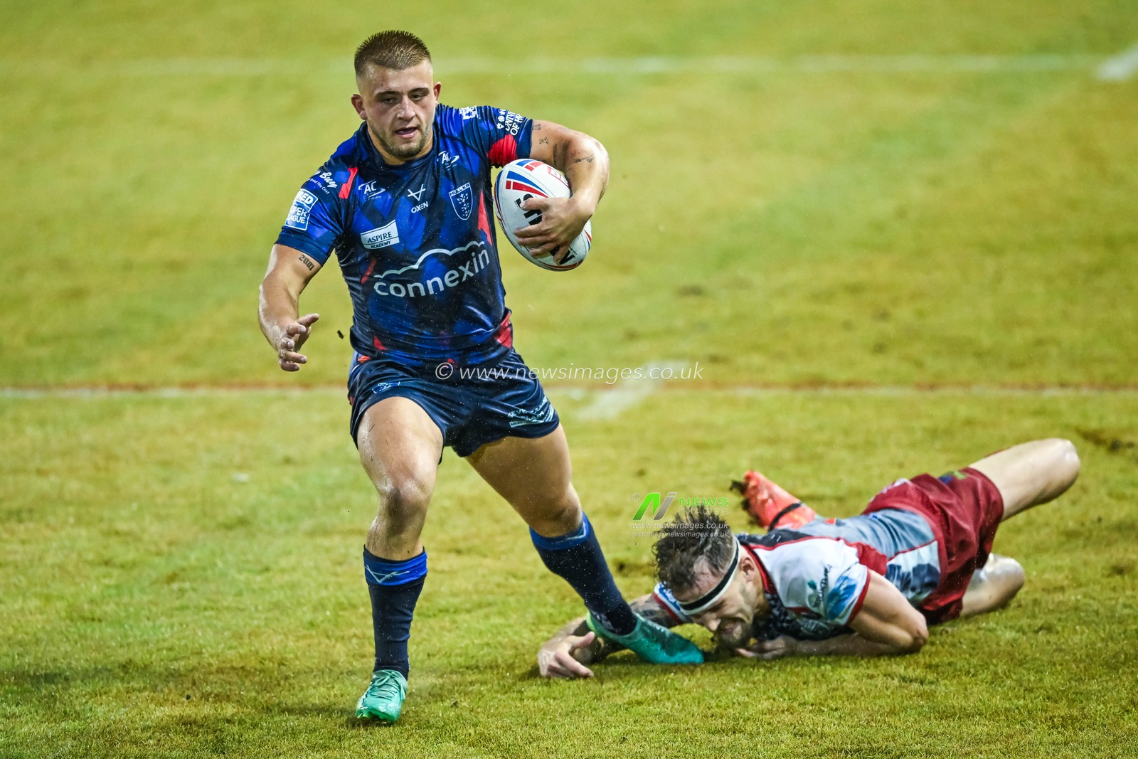 Mikey Lewis  #20 of Hull KR breaks the tackle of Ben Reynolds #15 of Leigh Leopards during the Betfred Super League Round 17 match Leigh Leopards vs Hull KR at Leigh Sports Village, Leigh, United Kingdom, 30th June 2023

(Photo by Craig Thomas/News Images)
