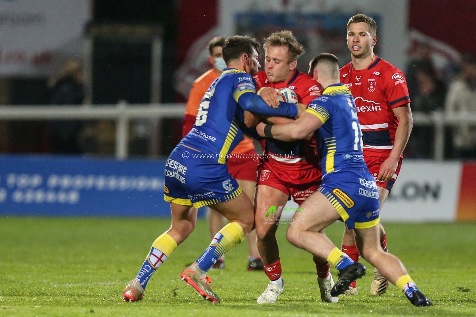 Jez Litten #14 of Hull KR is stopped by the Warrington defence