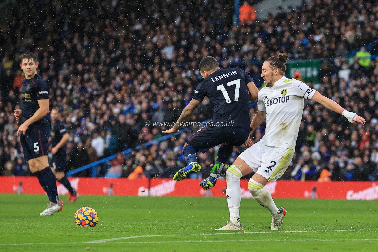 Luke Ayling #2 of Leeds United clears the ball under pressure form Aaron Lennon #17 of Burnley