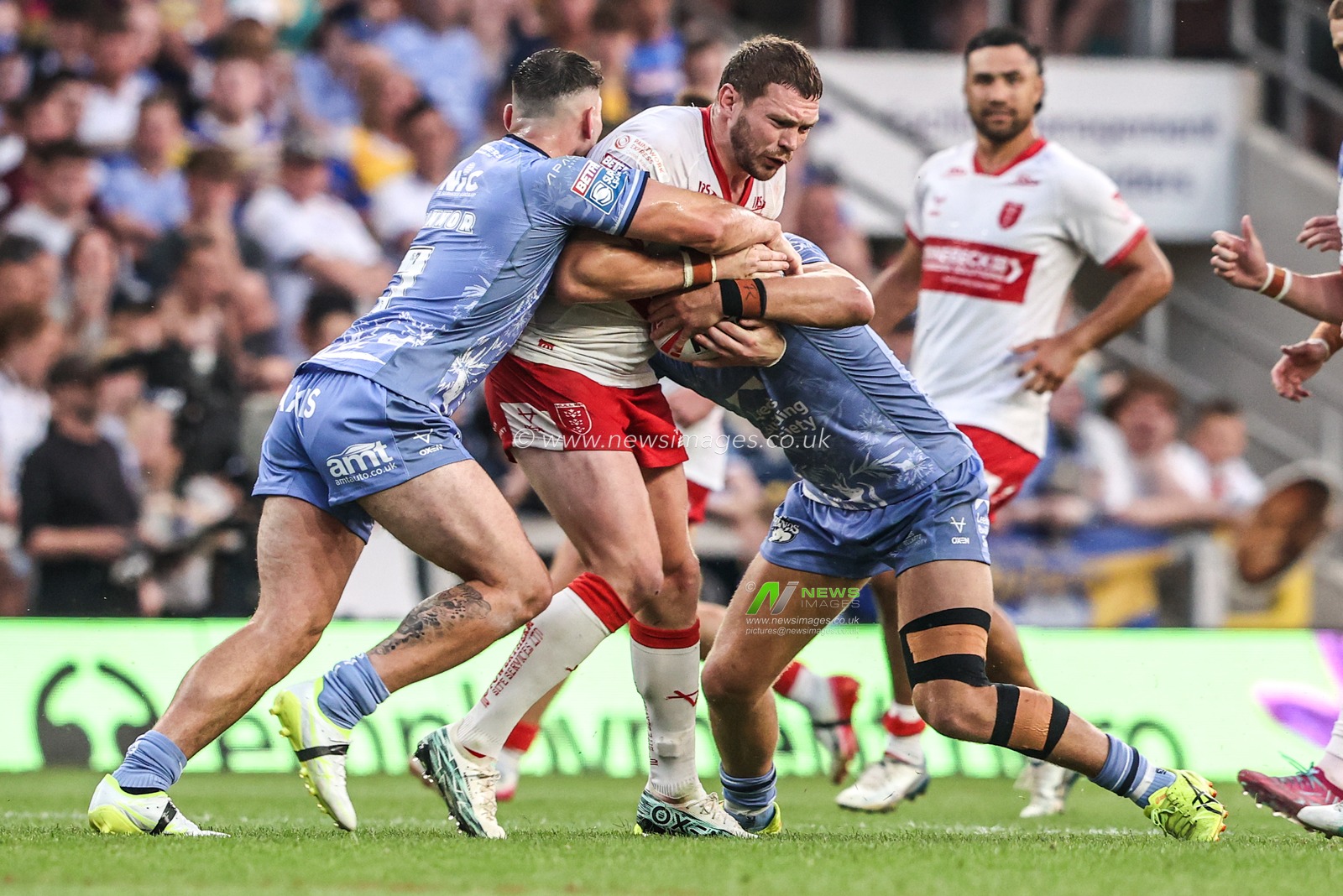 James Batchelor of Hull KR is tackled by Chris Hankinson of Leeds Rhinos and Jake Connor of Leeds Rhinos during the Betfred Super League round 16 match Leeds Rhinos vs Hull KR at AMT Headingley Stadium, Leeds, United Kingdom on 26 June 2026

(Photo by Alfie Cosgrove/News Images)