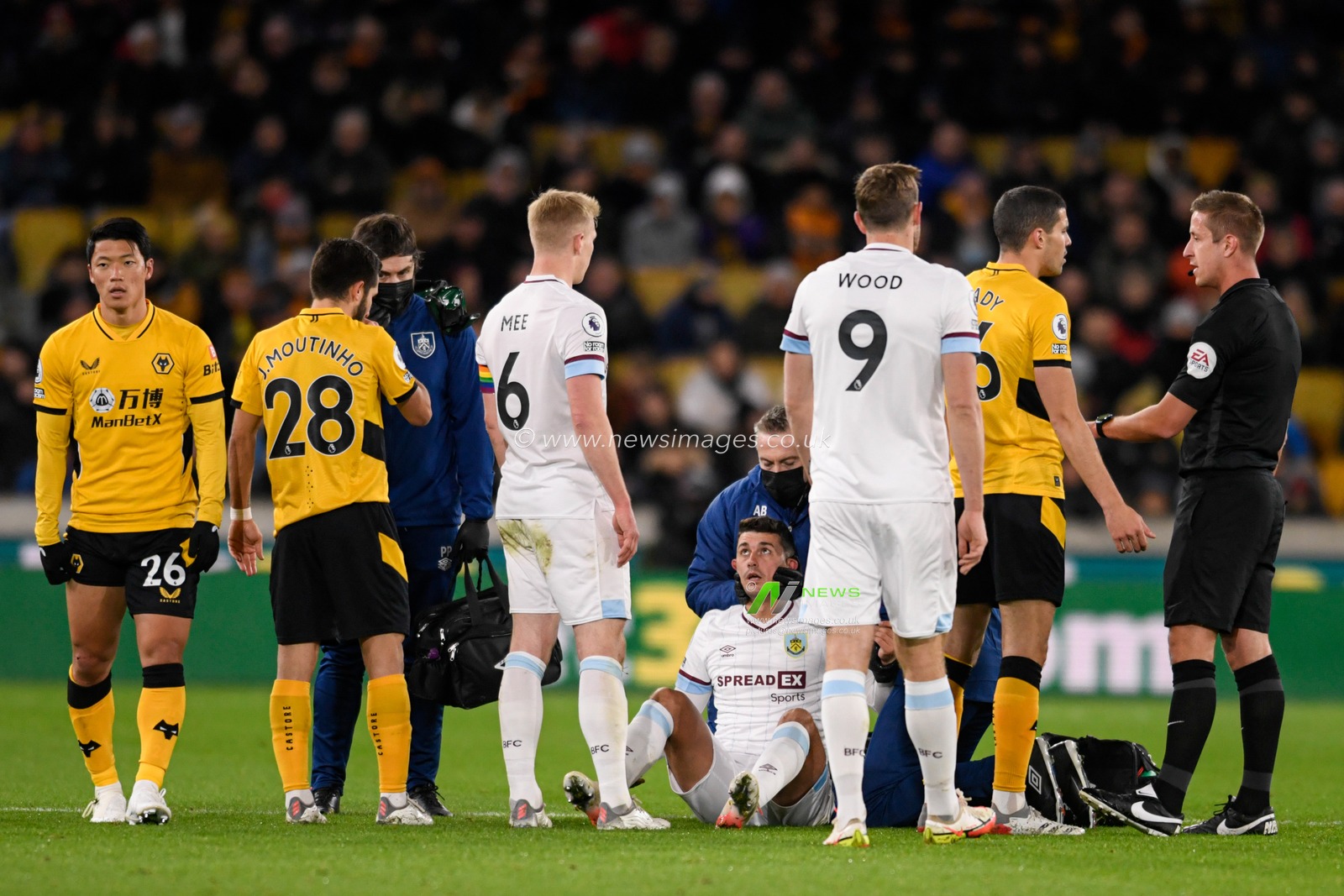 Matthew Lowton #2 of Burnley receives treatment on the pitch after an injury