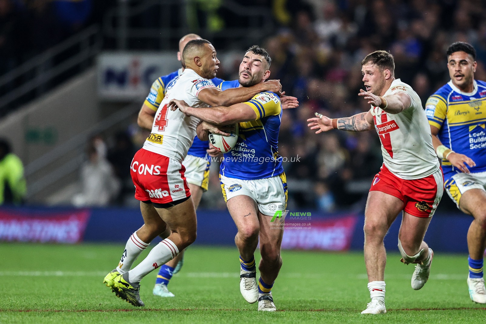 Moses Mbye of St. Helens pulls Jake Connor of Leeds Rhinos to the floor conceding a penalty during the Betfred Super League play-off Eliminator 1 match Leeds Rhinos vs St Helens at Headingley Stadium, Leeds, United Kingdom, 27th September 2025

(Photo by Alfie Cosgrove/News Images)