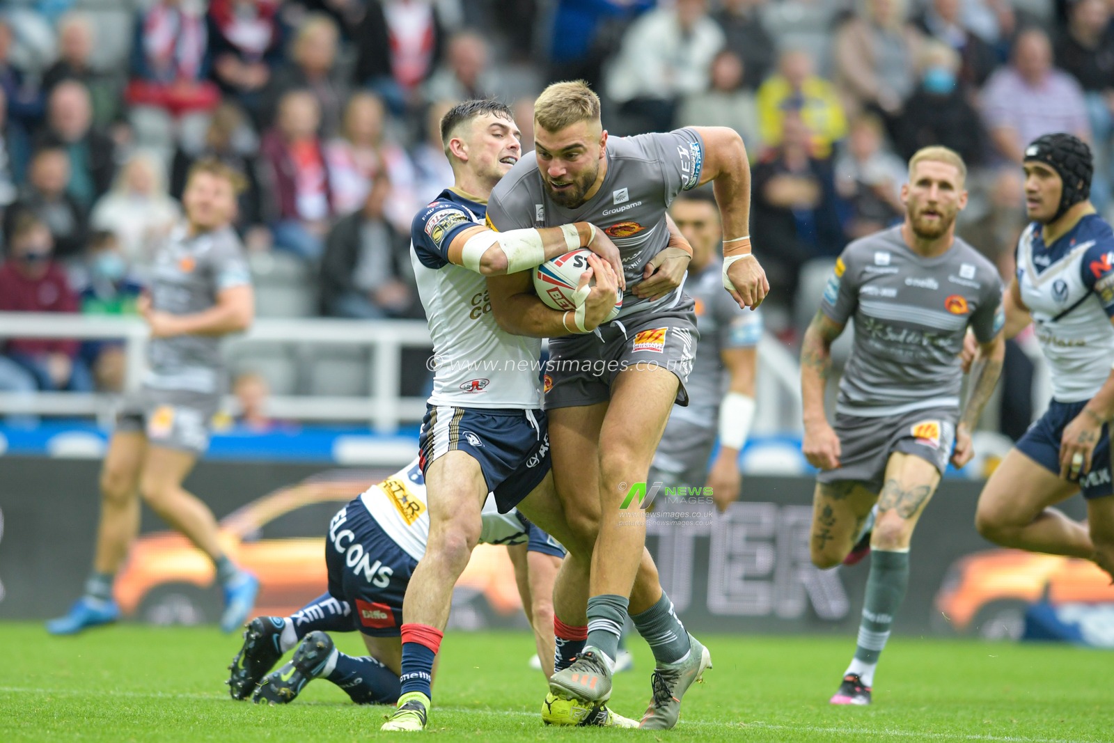 Mike McMeeken (12) of Catalans Dragons drives the ball forward