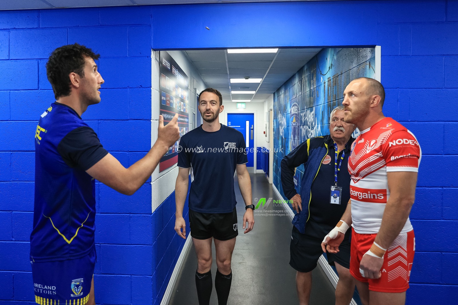 Stefan Ratchford #1 of Warrington Wolves flips the coin as referee James child  and James Roby #9 of St Helens watch over
