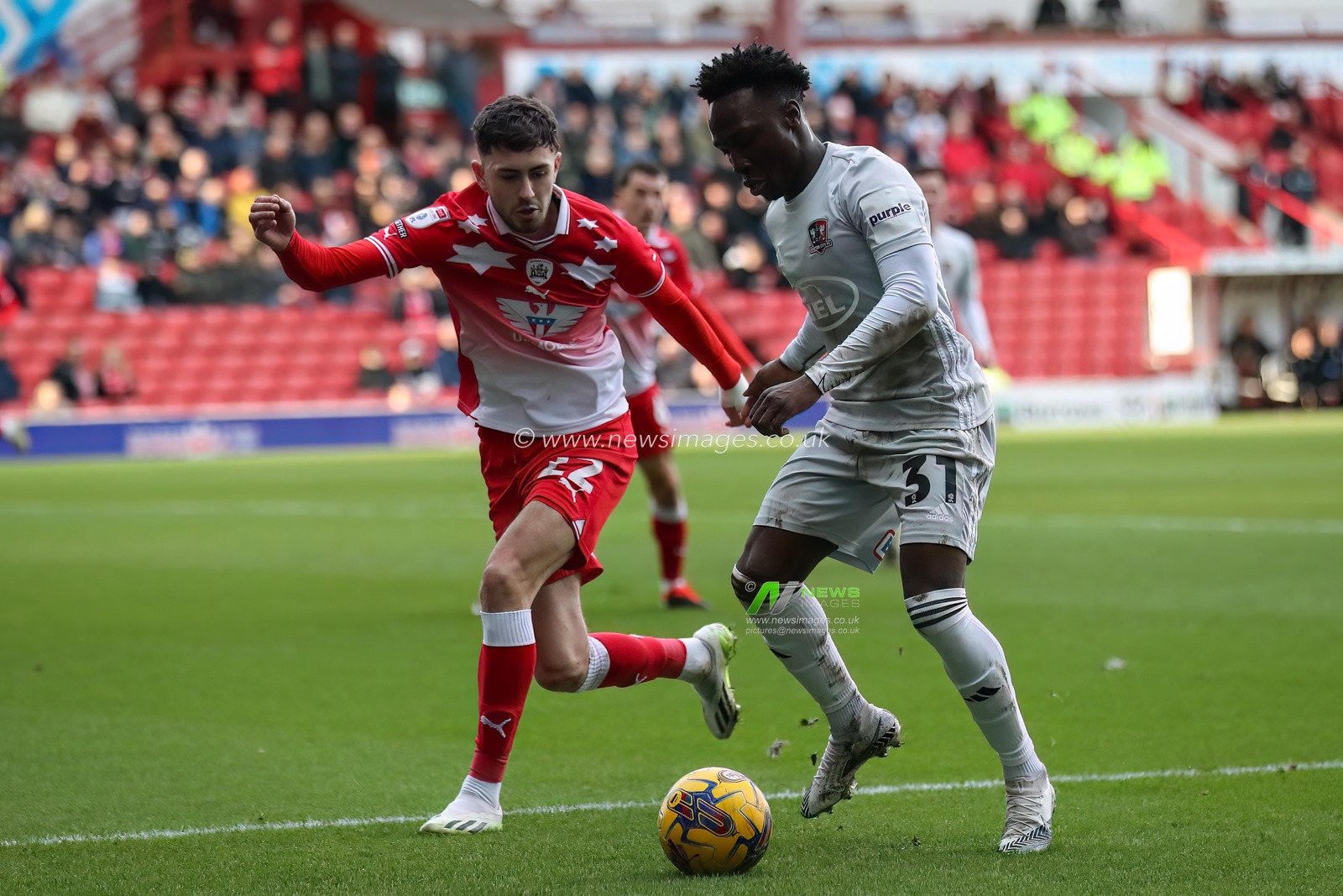 Vincent Harper of Exeter City holds the ball as Corey O'Keeffe of Barnsley pressures during the Sky Bet League 1 match Barnsley vs Exeter City at Oakwell, Barnsley, United Kingdom, 27th January 2024

(Photo by Alfie Cosgrove/News Images)