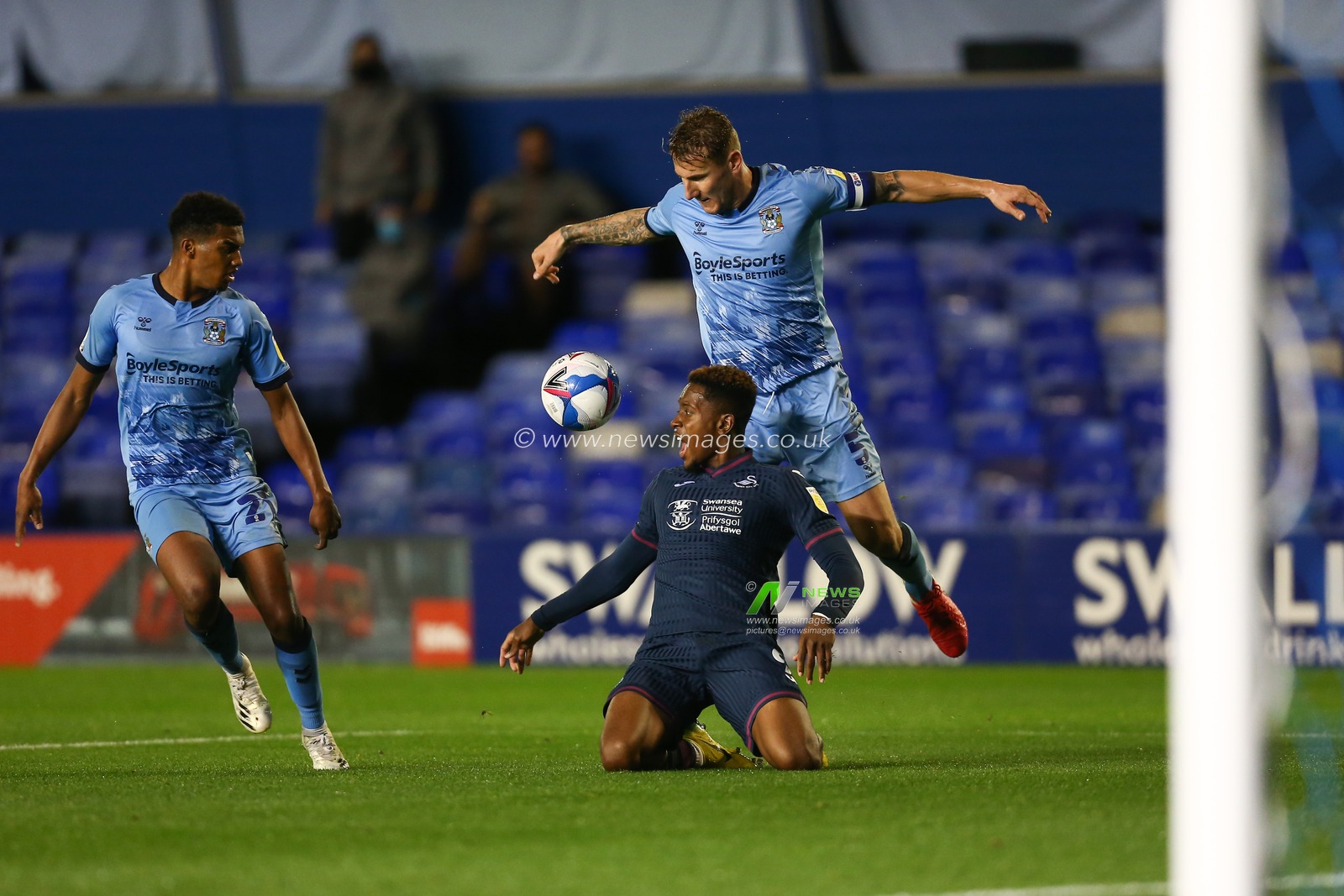 Jamal Lowe (9) of Swansea City is tackled by Kyle McFadzean (5) of Coventry City