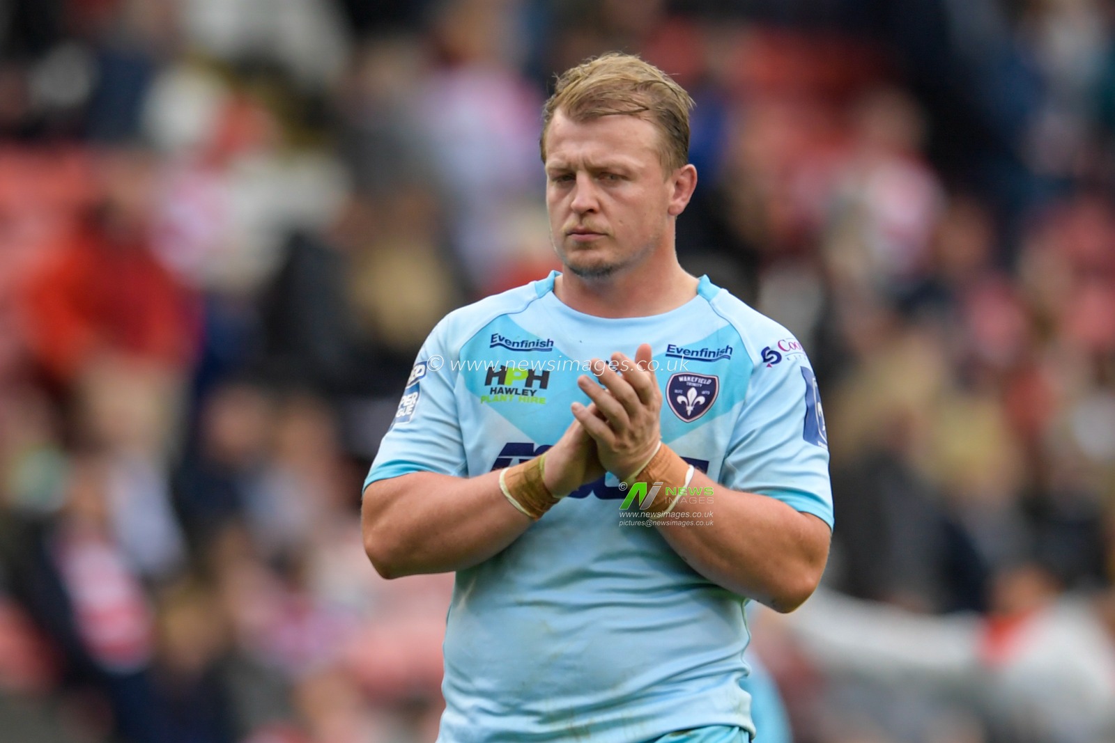 Eddie Battye (15) of Wakefield Trinity applauds the travelling supporters at the end of the game